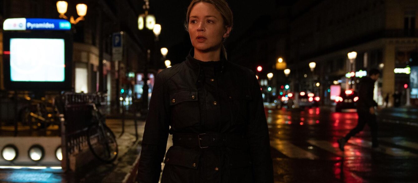 A Film Still from Revoir Paris with Virginia Efira wearing a leather jacker on a nighttime street.